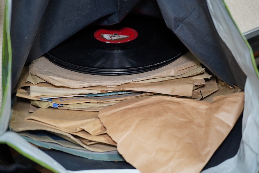 A mahogany cased HMV table top gramophone record player and a small selection of 78 rpm records. Condition - fair to good.